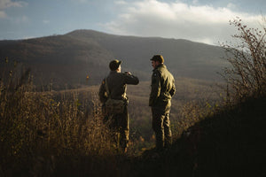 Vintage‑style soldiers on mountain hilltop at dusk