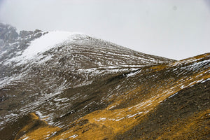 Alpine slope with scattered snow