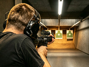 EZSHOOT rifle scope used by shooter aiming at targets in an indoor shooting range.